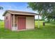 Outdoor utility shed with a combination of wood siding and access doors at 1504 N Knightstown Rd, Shelbyville, IN 46176