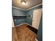 Convenient laundry area features a shelf for storage, a tiled floor, and a dark-colored accent wall at 2307 Blackthorn Dr, Franklin, IN 46131