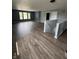 Open living space with hardwood floors, large windows, and adjacent rooms for flexible living options at 2307 Blackthorn Dr, Franklin, IN 46131