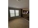 An open-concept living room features bright windows and transitions to a wood paneled kitchen wall at 2307 Blackthorn Dr, Franklin, IN 46131