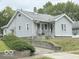 Charming single-Gathering home with light gray siding, a quaint porch and a chimney at , Anderson, IN 46013