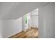 Finished attic space with wood flooring, white paneled walls and an open layout at 327 Central Ave, Anderson, IN 46012