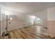 Finished attic space with wood floors, painted paneling, and sloped ceilings at 327 Central Ave, Anderson, IN 46012