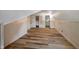 Finished attic space featuring wood floors, white paneled walls, and ample natural light at 327 Central Ave, Anderson, IN 46012