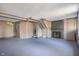 Basement with paneled walls, painted floor and a non-decorative fireplace at 327 Central Ave, Anderson, IN 46012