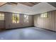 Basement with paneled walls, three windows and painted floor at 327 Central Ave, Anderson, IN 46012