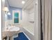 Bathroom with blue and white tile flooring and a combination shower and tub at 327 Central Ave, Anderson, IN 46012