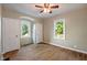 Bedroom featuring a ceiling fan, two windows, and two closets at 327 Central Ave, Anderson, IN 46012