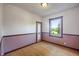 Empty bedroom with hardwood floors and natural light from a window at 327 Central Ave, Anderson, IN 46012