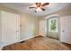 Bedroom featuring a ceiling fan, a window, and two closets at 327 Central Ave, Anderson, IN 46012