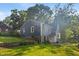 Charming blue two-story home with well-maintained lawn and mature trees at 327 Central Ave, Anderson, IN 46012