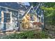 Charming blue home showcasing a stone accent, flower boxes on the porch and a landscaped garden at 327 Central Ave, Anderson, IN 46012