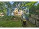 Charming blue home with lovely flower boxes on the porch, lawn, garden, and a side entrance at 327 Central Ave, Anderson, IN 46012