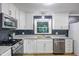 Bright kitchen featuring granite counters, stainless steel appliances, white cabinets and backsplash at 327 Central Ave, Anderson, IN 46012