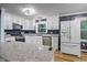 Well-lit kitchen featuring stainless steel appliances and a spacious granite countertop island at 327 Central Ave, Anderson, IN 46012