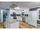 A bright kitchen is equipped with stainless steel appliances, white cabinets, and a center island at 327 Central Ave, Anderson, IN 46012