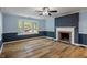 Cozy living room features a large bay window, fireplace, light-colored walls, and wood floors at 327 Central Ave, Anderson, IN 46012