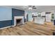 Open-concept living room and kitchen featuring light-colored walls, a fireplace, and light-colored cabinets at 327 Central Ave, Anderson, IN 46012