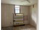 Bedroom features wood paneling with window and shelving unit at 850 N Anderson St, Elwood, IN 46036
