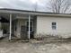 Side view of house with vinyl siding, stone foundation and porch area at 850 N Anderson St, Elwood, IN 46036