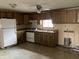 Functional kitchen equipped with white appliances and wood cabinets at 850 N Anderson St, Elwood, IN 46036