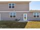A view of the home's gray exterior with a door leading to the backyard and large windows for natural light at 6286 Wasco Dr, Whitestown, IN 46075