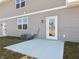 A backyard concrete patio with multiple access doors to the home at 6286 Wasco Dr, Whitestown, IN 46075