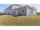 Exterior view showing a gray home with a concrete patio and green lawn at 6286 Wasco Dr, Whitestown, IN 46075
