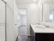 Bright bathroom featuring a double vanity with dark cabinetry, white countertops, and modern fixtures at 6286 Wasco Dr, Whitestown, IN 46075