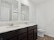 Bright bathroom features a double vanity with dark cabinetry and modern fixtures, complemented by wood-look flooring at 6286 Wasco Dr, Whitestown, IN 46075