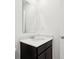A clean and modern bathroom vanity with sink, mirror, and dark wood cabinets at 6286 Wasco Dr, Whitestown, IN 46075
