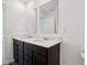 Bright bathroom featuring a double vanity with dark cabinetry, white countertops, and modern fixtures at 6286 Wasco Dr, Whitestown, IN 46075