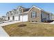 Long view of a street showcasing the attractive townhomes and well-maintained lawns at 6286 Wasco Dr, Whitestown, IN 46075
