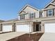 Exterior showing a two-car garage, neutral siding, and a young tree in the front yard at 6286 Wasco Dr, Whitestown, IN 46075