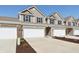 A row of townhomes with two-car garages and driveways, showcasing the community's layout at 6286 Wasco Dr, Whitestown, IN 46075