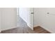 Hallway featuring neutral carpet and white doors and trim, creating a clean and open feel at 6286 Wasco Dr, Whitestown, IN 46075