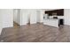 Open kitchen concept featuring modern appliances, dark cabinets, white island, and hardwood floors at 6286 Wasco Dr, Whitestown, IN 46075
