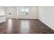 Spacious living room with hardwood floors, white walls, and a large window for lots of natural light at 6286 Wasco Dr, Whitestown, IN 46075