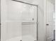 Bright and clean bathroom featuring a white tiled shower with a sliding glass door and modern fixtures at 6286 Wasco Dr, Whitestown, IN 46075