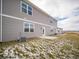 The backyard shows a patio, grass, and a gray-sided house with white trim and multi-paned windows at 6296 Wasco Dr, Whitestown, IN 46075