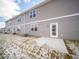 The backyard shows a patio, grass, and a gray-sided house with white trim and multi-paned windows at 6296 Wasco Dr, Whitestown, IN 46075