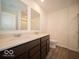 Bright bathroom featuring a double sink vanity with dark wood cabinets and modern fixtures at 6296 Wasco Dr, Whitestown, IN 46075