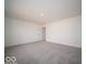 An oversized bedroom has neutral carpet, an entry door, and is freshly painted at 6296 Wasco Dr, Whitestown, IN 46075
