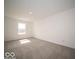 Bright, empty bedroom with large window and neutral carpet at 6296 Wasco Dr, Whitestown, IN 46075