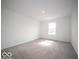 Sunlit bedroom showcasing neutral carpeting and a window letting in natural light at 6296 Wasco Dr, Whitestown, IN 46075