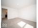 Spacious bedroom featuring neutral carpeting, white walls, and a view into the bathroom at 6296 Wasco Dr, Whitestown, IN 46075
