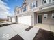 A modern townhome featuring a two-car garage, black front door, and well-maintained landscaping at 6296 Wasco Dr, Whitestown, IN 46075