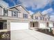 Street view of new townhomes with attached garages, attractive landscaping, and modern design elements at 6296 Wasco Dr, Whitestown, IN 46075