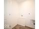 A minimalist laundry room featuring wood-look flooring with white walls and door at 6296 Wasco Dr, Whitestown, IN 46075