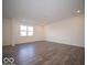 Large open living space offering plenty of natural light and hardwood laminate floors at 6296 Wasco Dr, Whitestown, IN 46075